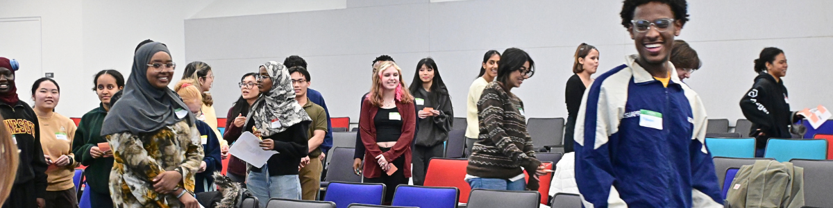 Students smile while walking to their seats at the First to Go Kickoff.