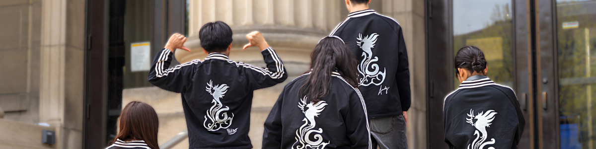First-Gen Interns pose on the steps of Walter Library, showing off their first-gen sweatshirts.