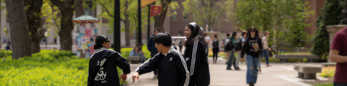 Students laughing and hanging out on the East Bank mall.